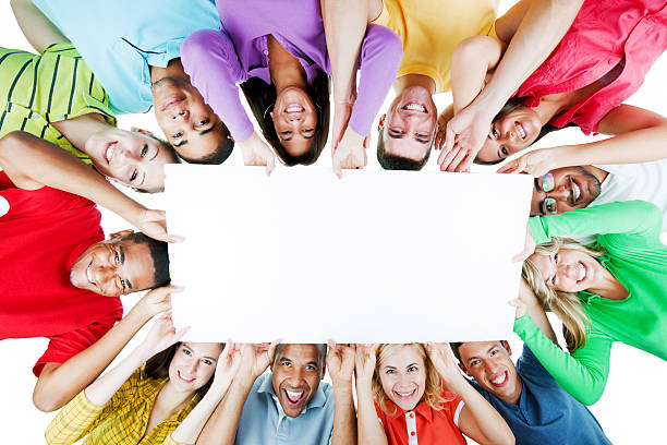 istock Cheerful group holding a big white paper. 184612176