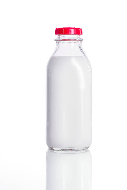 Fresh glass bottle of milk with a red lid Fresh Milk milk bottle stock pictures, royalty-free photos & images