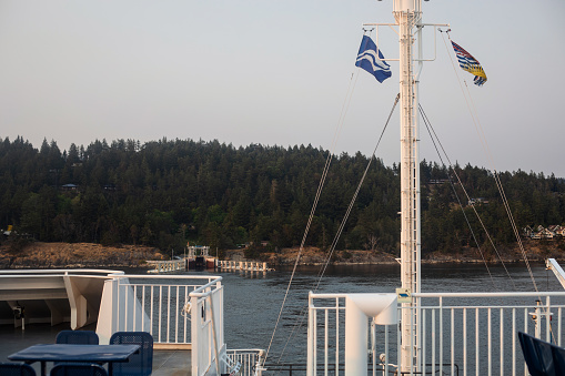Pender Island, Canada - August 19, 2023. Pender Island fades into the distance as a ferry departs from this southern Gulf Island off of Vancouver Island.