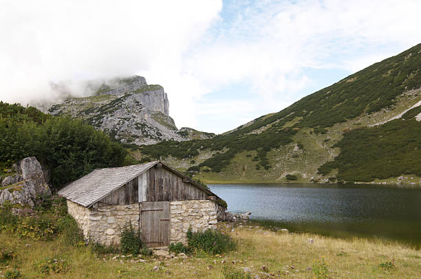 Log cabins and a drinking fountain in the Alps