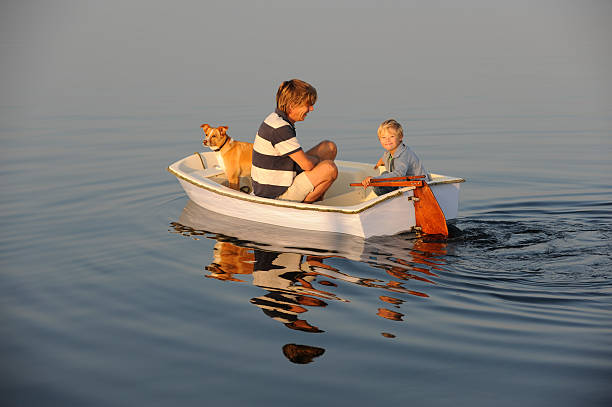 istock Father, son and dog in a small boat 184613027