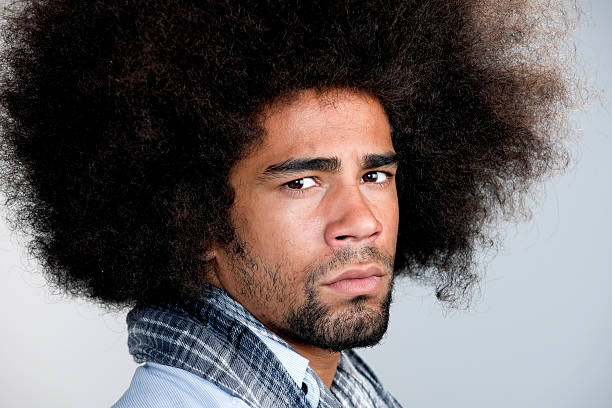 istock frowning man with big afro hair 184614114