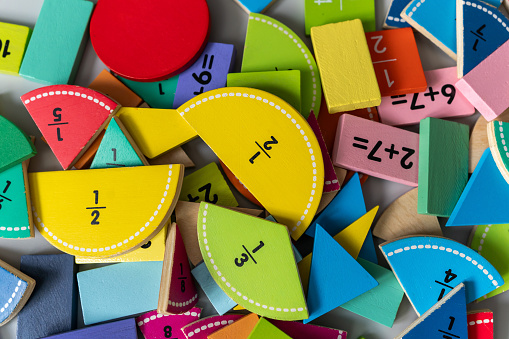 back to school background. Close up colorful wooden fractions on the table. Mathematics in preschool and school