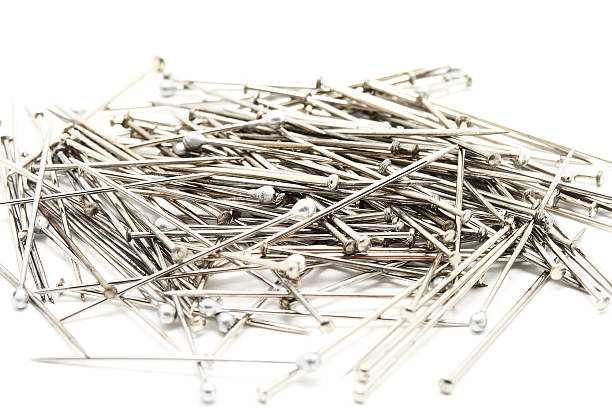 istock Heap of small pins on white background 184614333