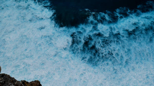 istock Turquoise ocean sea water white wave pattern splashing deep blue sea. Seascape dark ocean background wave splash on rock. Tropical sea beach in summer seaside outdoor. Water Surface blue wave pattern 1846143705