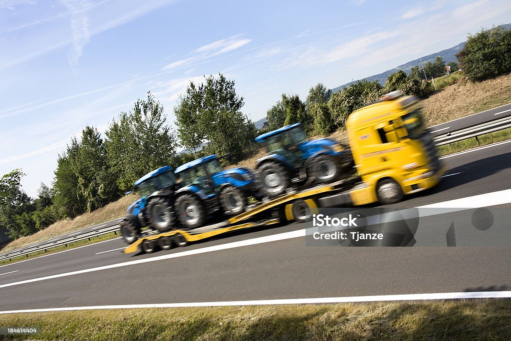 Truck Truck loaded with tractors in high speed.Motion blur. Freight Transportation Stock Photo