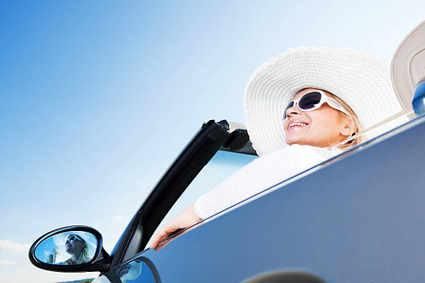 istock Happy woman driving a cabriolet car. 184615081