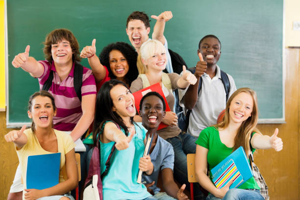 istock Cheerful students looking at the camera with their thumbs up. 184615097
