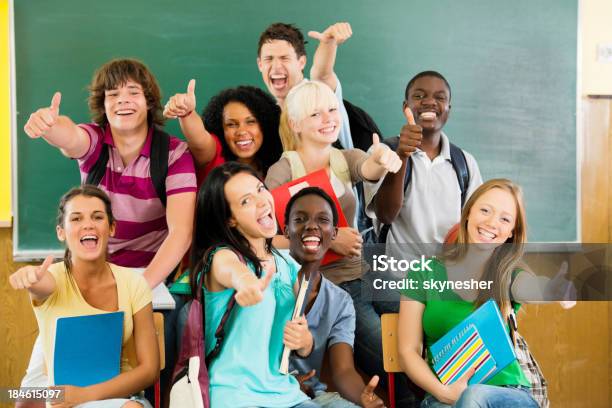 Cheerful Students Looking At The Camera With Their Thumbs Up Stock Photo - Download Image Now