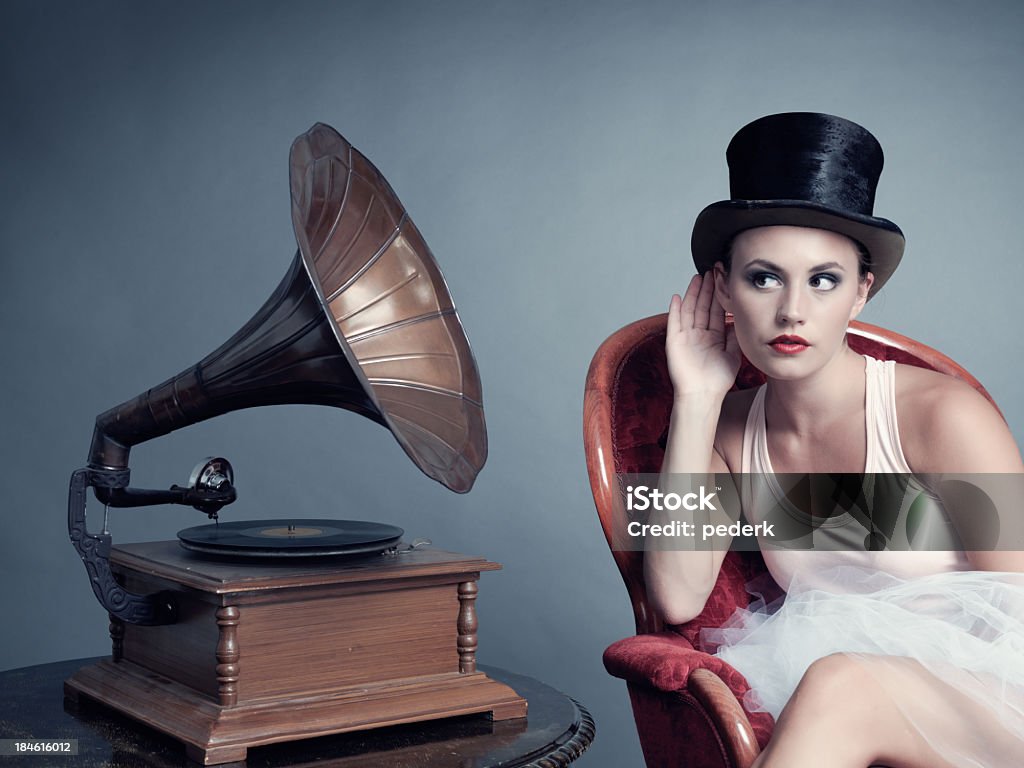 Woman listening to music Retro /cabaré look of woman listening to music Adult Stock Photo
