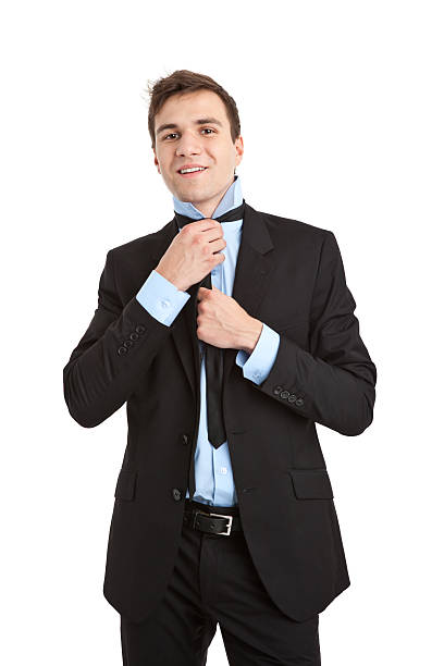 istock young handsome businessman tying tie 184616027