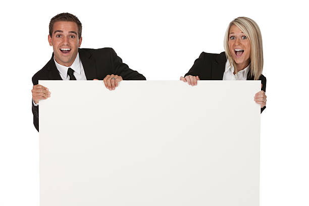 istock Surprised business couple with a placard 184616058