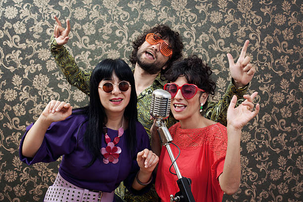 istock Three friends in seventies style singing on old fashioned microphone 184616159