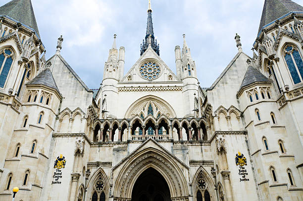 The Royal Courts of Justice in London, England "Facade of the Royal Courts of Justice along the Strand in the City of Westminster in London, England. Other images of the Royal Courts of Justice:" royal courts of justice stock pictures, royalty-free photos & images