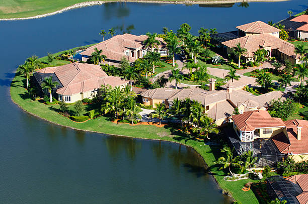 Lakefront Homes "Luxury lakefront homes in a residential neighborhood in Naples, Florida.  Taken from a helicopter at 500 feet." collier county stock pictures, royalty-free photos & images
