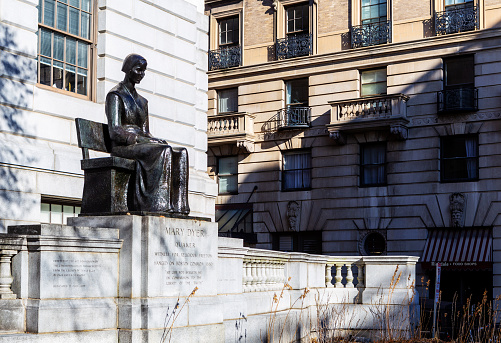 Boston, Massachusetts, USA - December 8, 2023:  A statue of Quaker religious martyr Mary Dyer by Sylvia Shaw Judson installed outside the Massachusetts State House, in Boston, Massachusetts. The monument inscription is \
