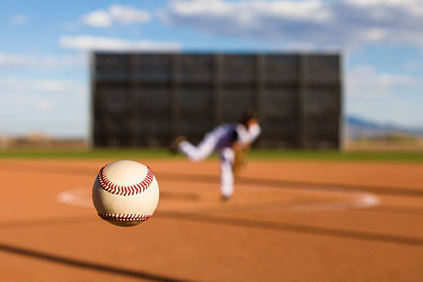 Baseball Pitch Baseball delivered by the pitcher is frozen in mid-air baseball pitcher stock pictures, royalty-free photos & images