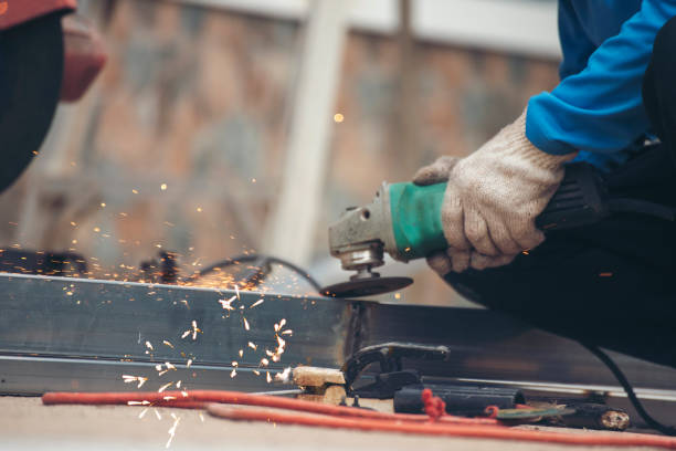 istock Construction Worker hands using Welding machinery iron metal sparking. Men hands wear protective glove Hot flame metal work cutting fire iron workshop. Locksmith use Welding machine cut metal process 1846168231
