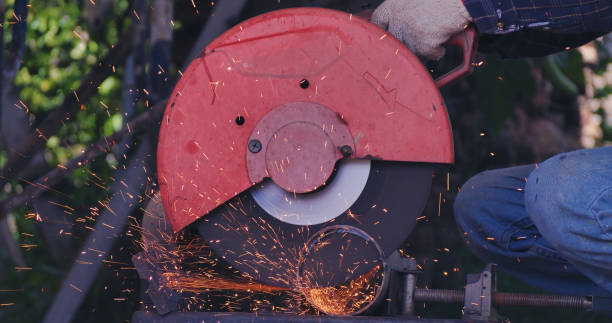 istock Hot flame welding metal work cutting fire iron workshop. Welding machine iron metal sparking. Locksmith using Welding machine cutting metal processing grinder. Close up hands Sparks in metalworking 1846168294