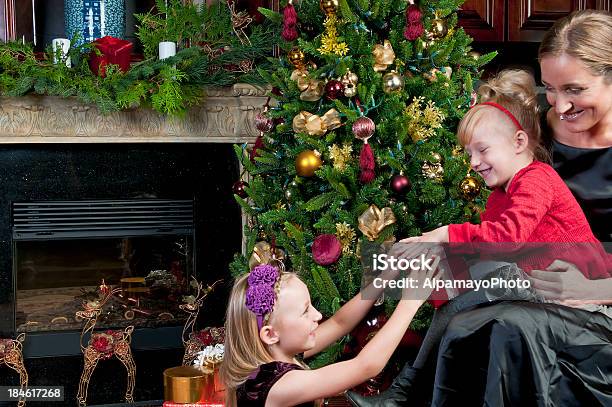 Mother And Daughters Opening Gifts On A Christmas Day Stock Photo - Download Image Now