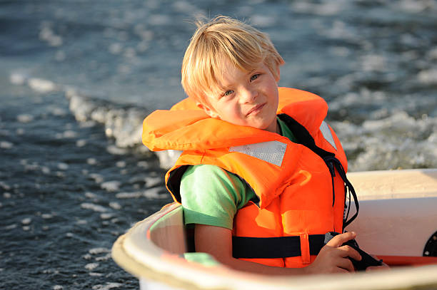 istock boy with life-jacket in boat 184617368
