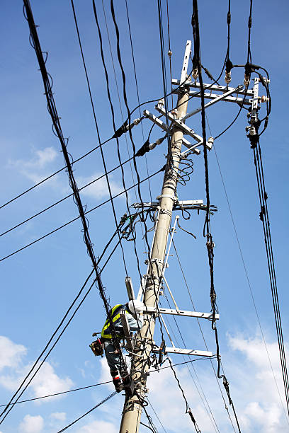 istock Electrician repairs a power line 184617383