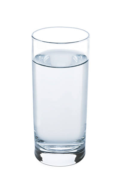 tea glass of water standing on table with blue and white cloth