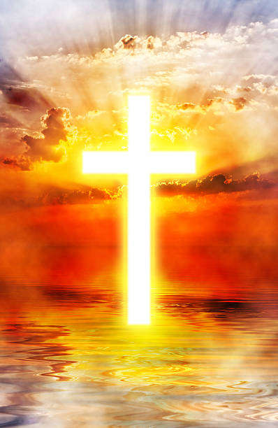istock Cross appearing on sunrise sky 184618072