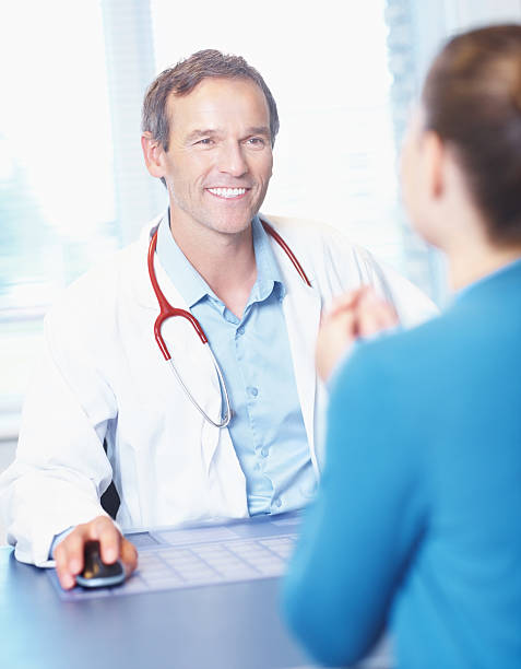 istock Doctor with patient in office 184618213