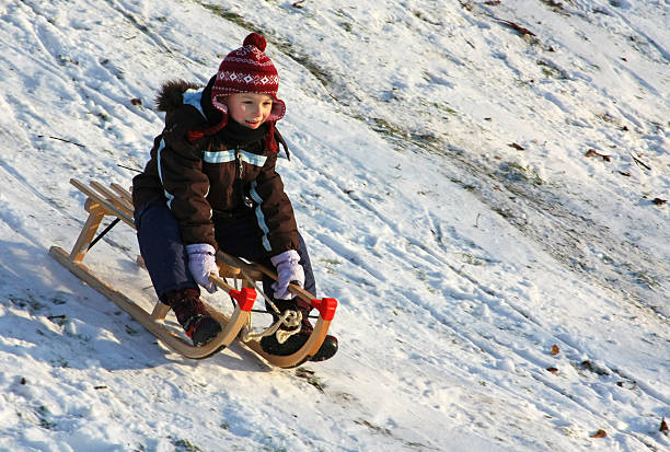 istock Little girl sledding downhill 184618279