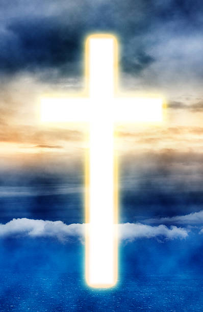 istock Cross appearing on sunrise sky 184618391