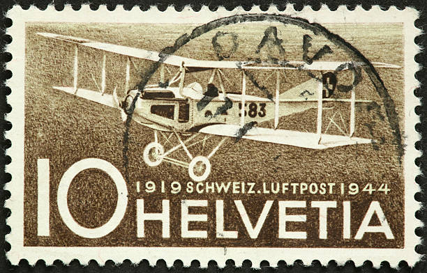 istock vintage 1919 biplane on an old Swiss postage stamp 184618393