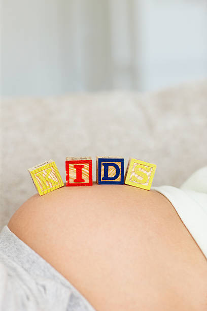 istock Woman with letter blocks on belly 184618634