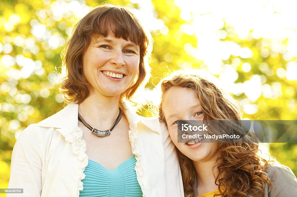 Mother And Daughter Mother an daughter posing in the park on a sunny autumn day. 10-11 Years Stock Photo