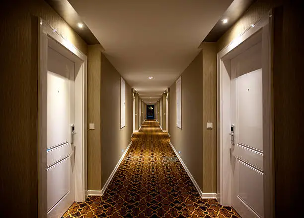 Long and dark hotel corridor. Indoor architectural Feature.
