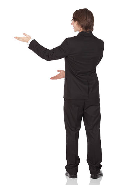 istock Rear view of a businessman gesturing 184618945