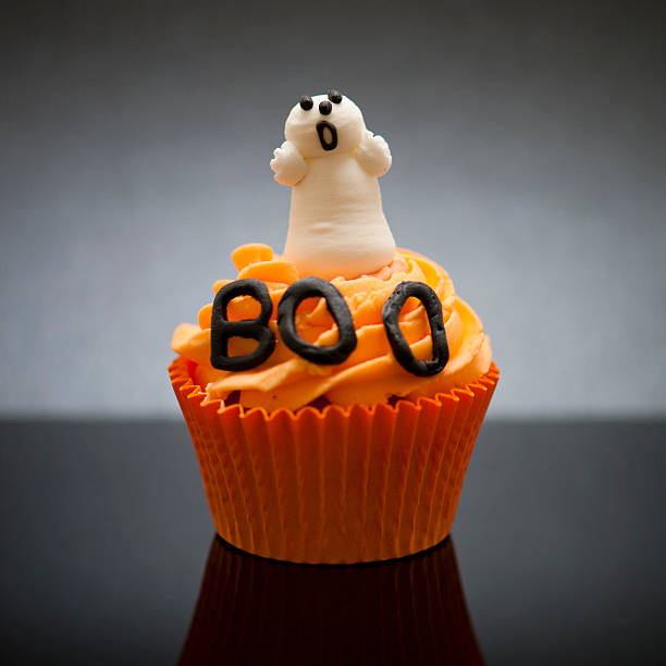 Halloween Cupcake with ghost Orange halloween cupcake with ghost decoration halloween cupcake stock pictures, royalty-free photos & images