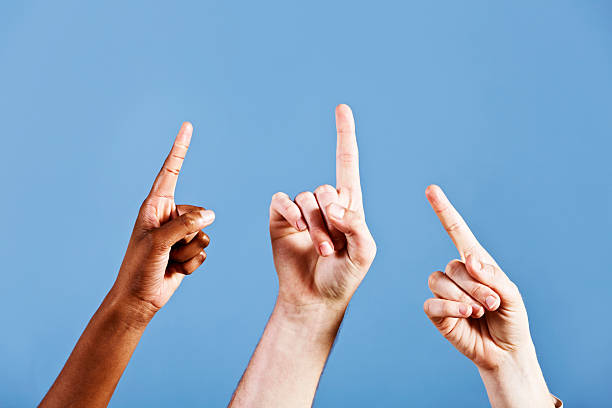 istock Three hands point up at something in the sky 184619297