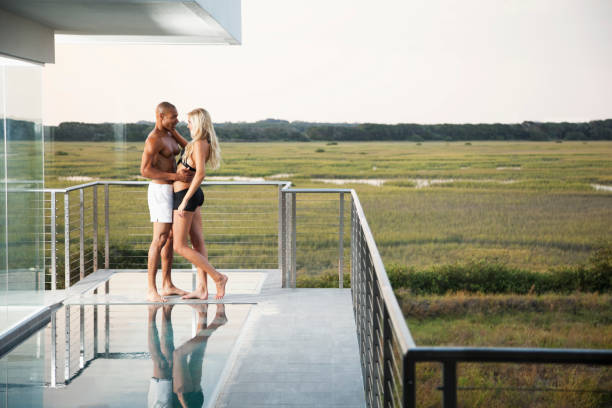 istock Interracial couple embracing on terrace 184619313