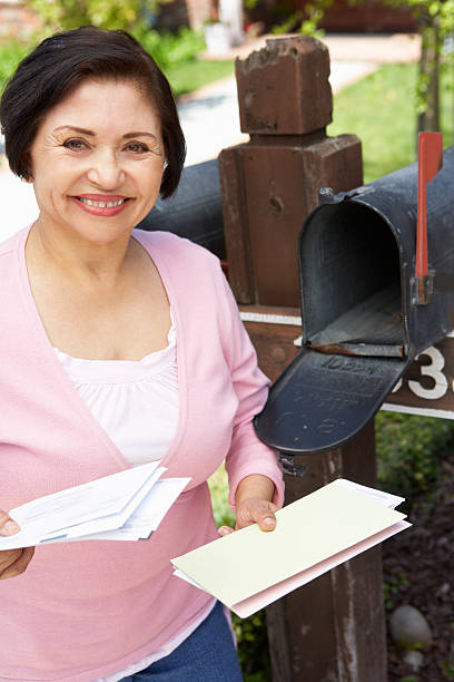 istock Senior Hispanic Woman Checking Mailbox 184619577