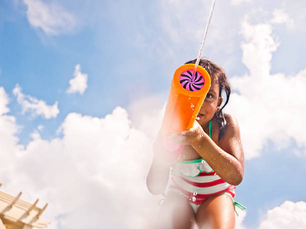 istock little girl with water blaster 184619626