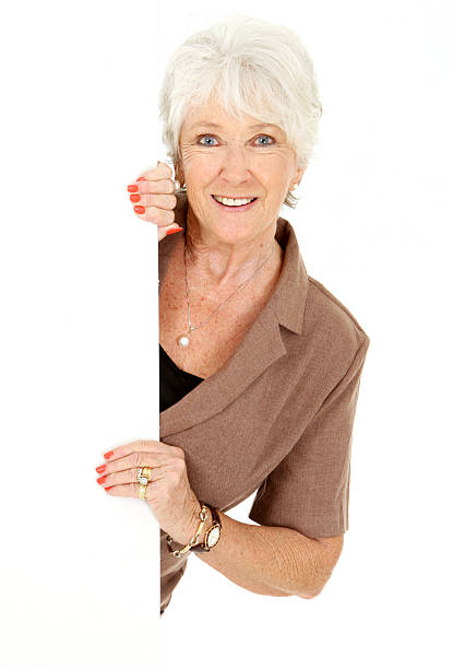 istock Attractive Mature Woman Peeking around edge 184619695