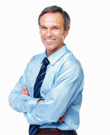 Portrait of handsome male executive smiling with arms crossed over white background