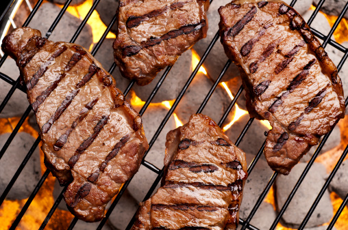 New York strip steak on the grill.  Please see my portfolio for other food related images.