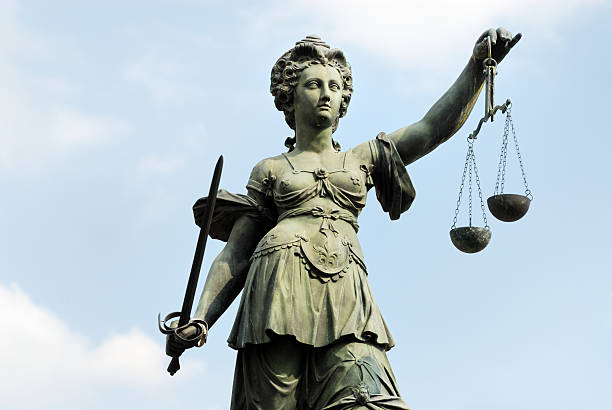 istock Justitia statue featuring woman and balance scale 184620454