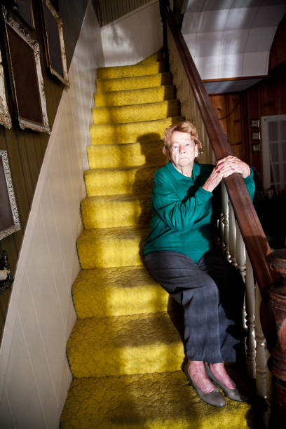 istock Senior woman sitting on staircase 184620540
