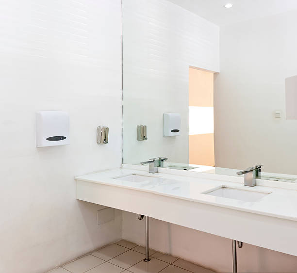 istock Washbasins, taps and mirror in a public toilet 184621076