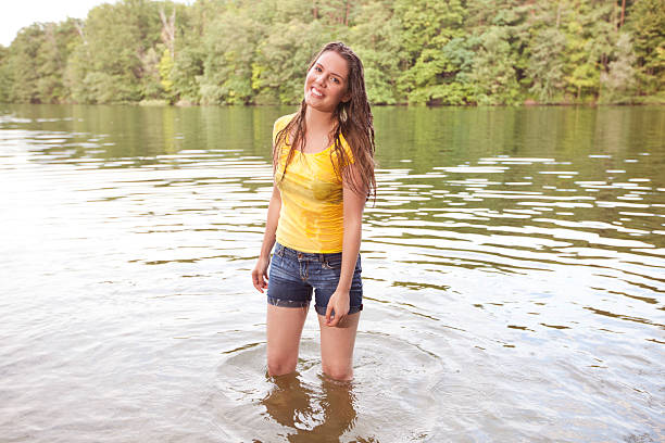 young woman cooling near the fountain in hot day