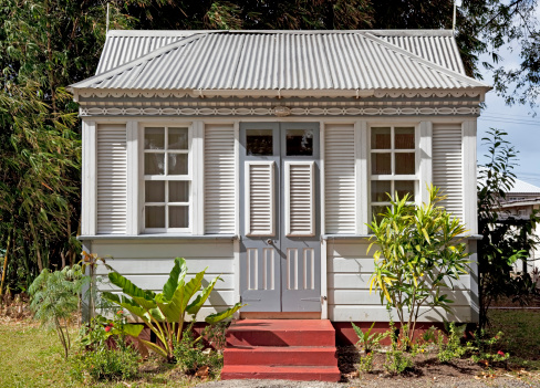A typical traditional small chattel house in Barbados. Wooden construction with a metal roof.