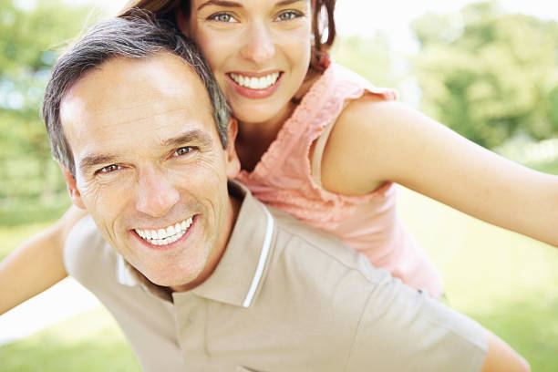 istock Playful couple in park 184621473